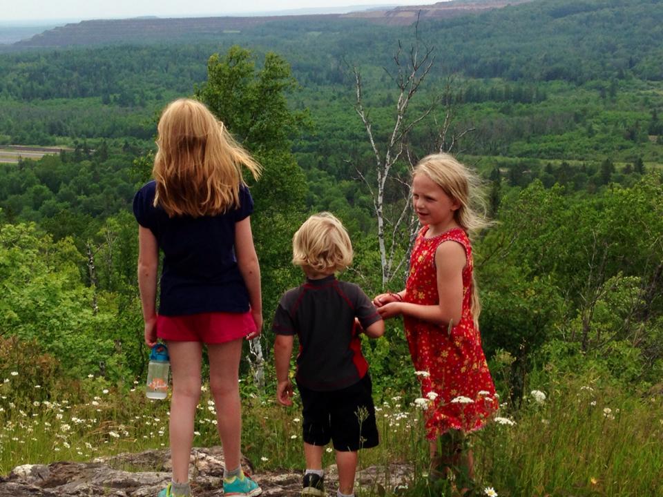 3 kids overlooking the trees and mines near Laurentian Divide