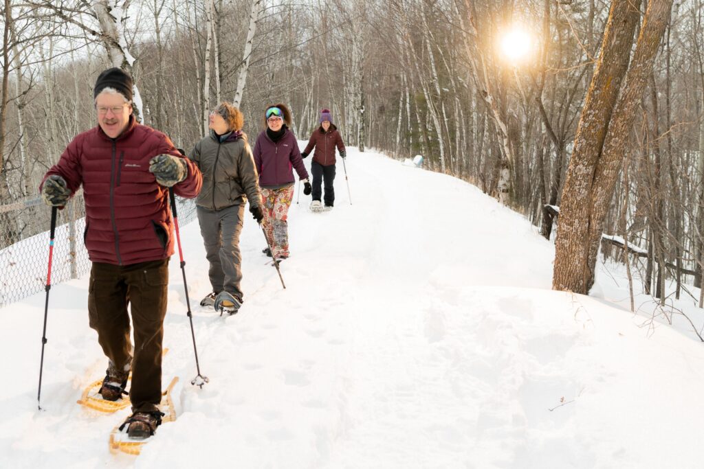 Four people snowshoeing in northern Minnesota