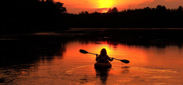 Kayaker on a sunlit lake in Minnesota
