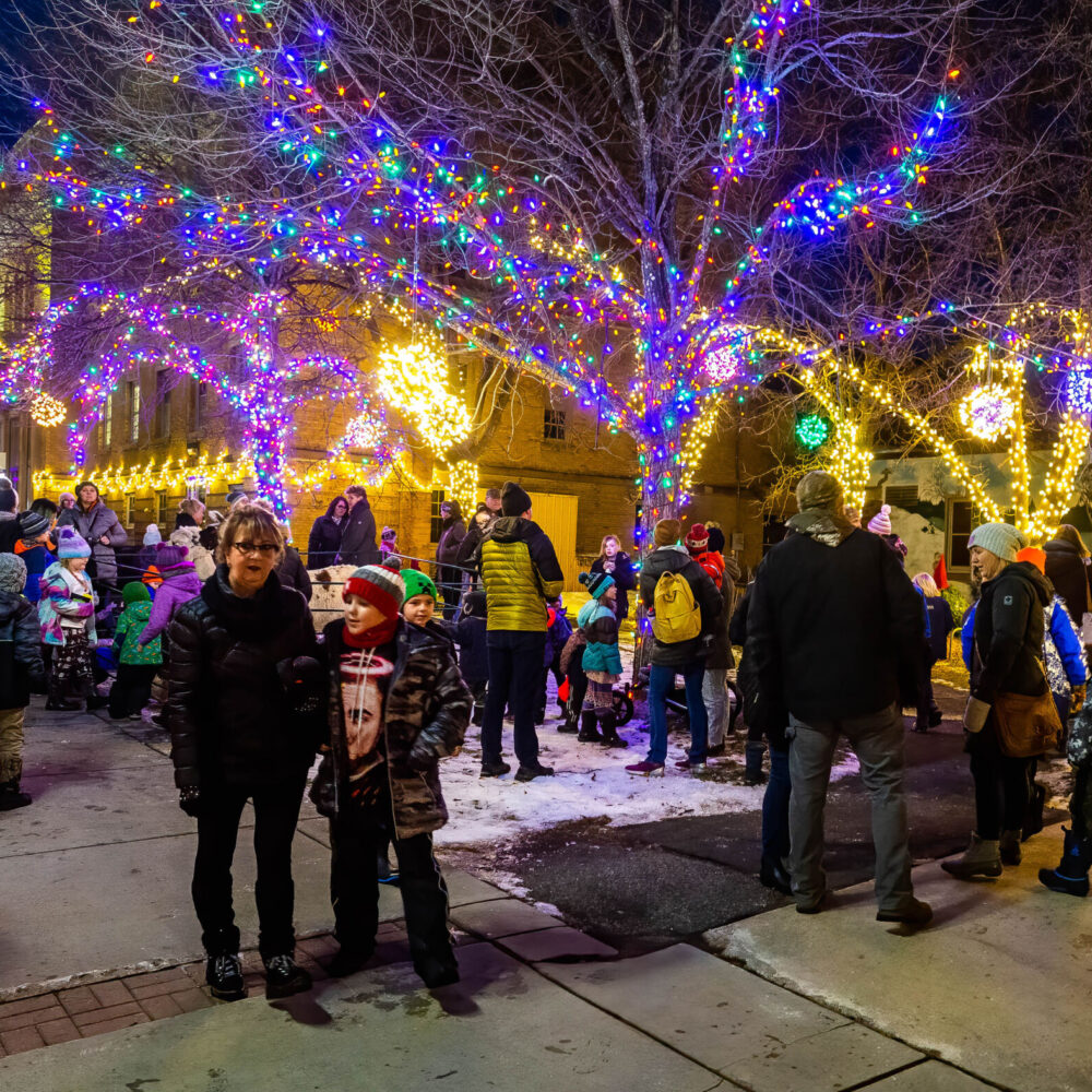 Familes gather around the Chisholm, MN City Hall and Library Thursday evening the celebrate the holidays.