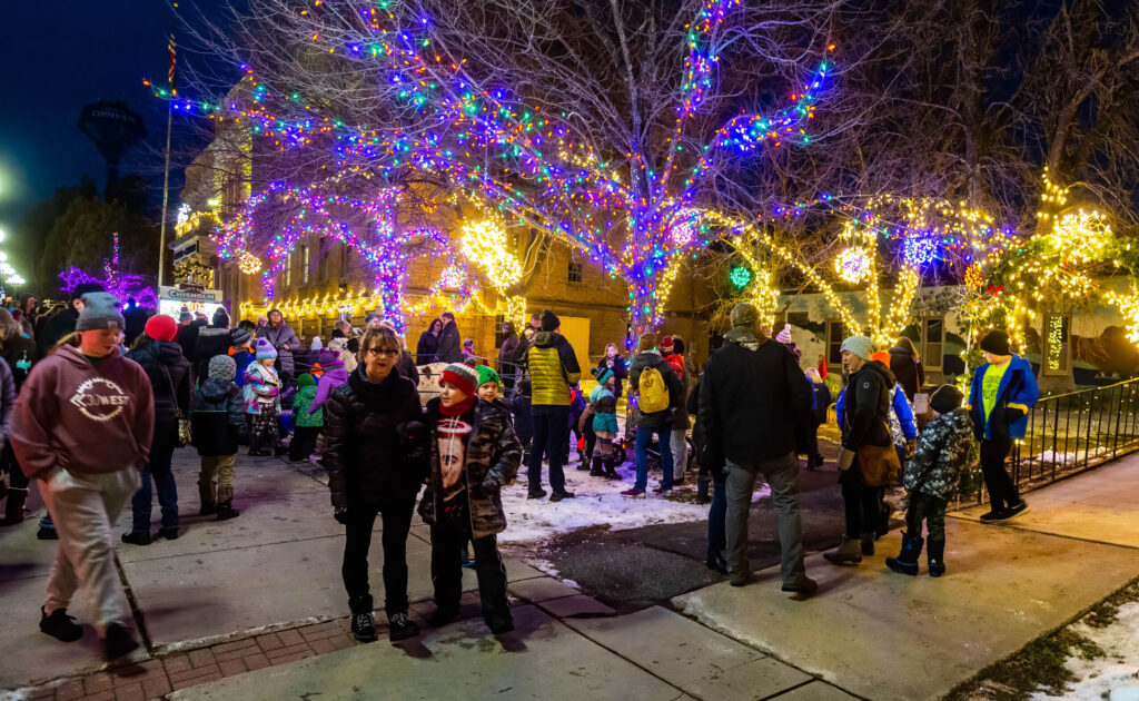 Familes gather around the Chisholm, MN City Hall and Library Thursday evening the celebrate the holidays.