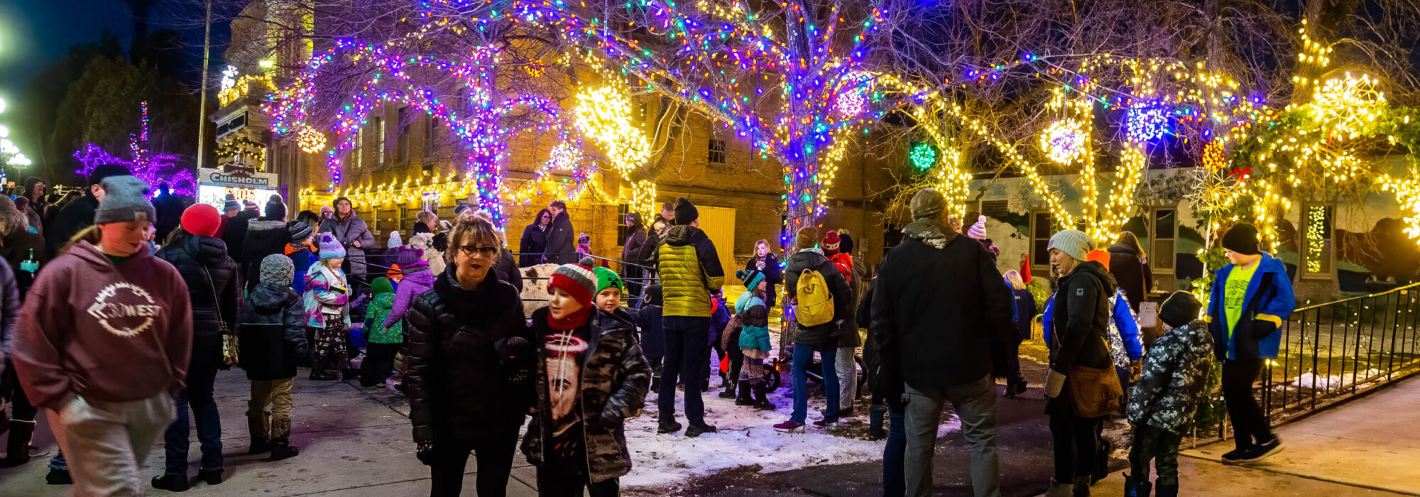 Familes gather around the Chisholm, MN City Hall and Library Thursday evening the celebrate the holidays.