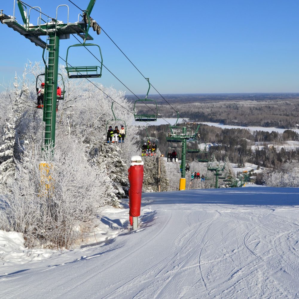The ski slopes of Giants Ridge resort in northern Minnesota are shown in winter with full ski lifts.