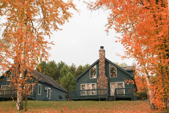 Fall leaves frame a view of a rental villa at Giants Ridge in northern Minnesota