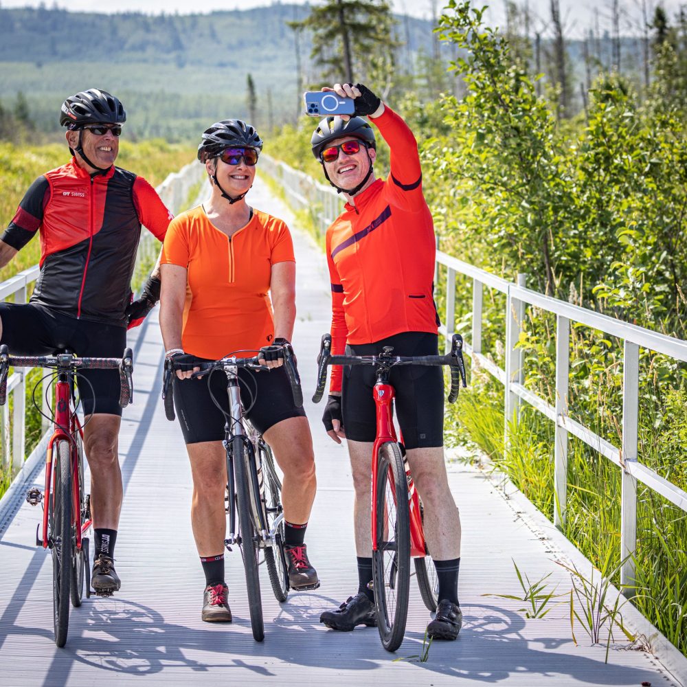 Cyclists on the Mesabi Trail pause for a selfie on a floating bridge in a Minnesota wildlife Management Area.