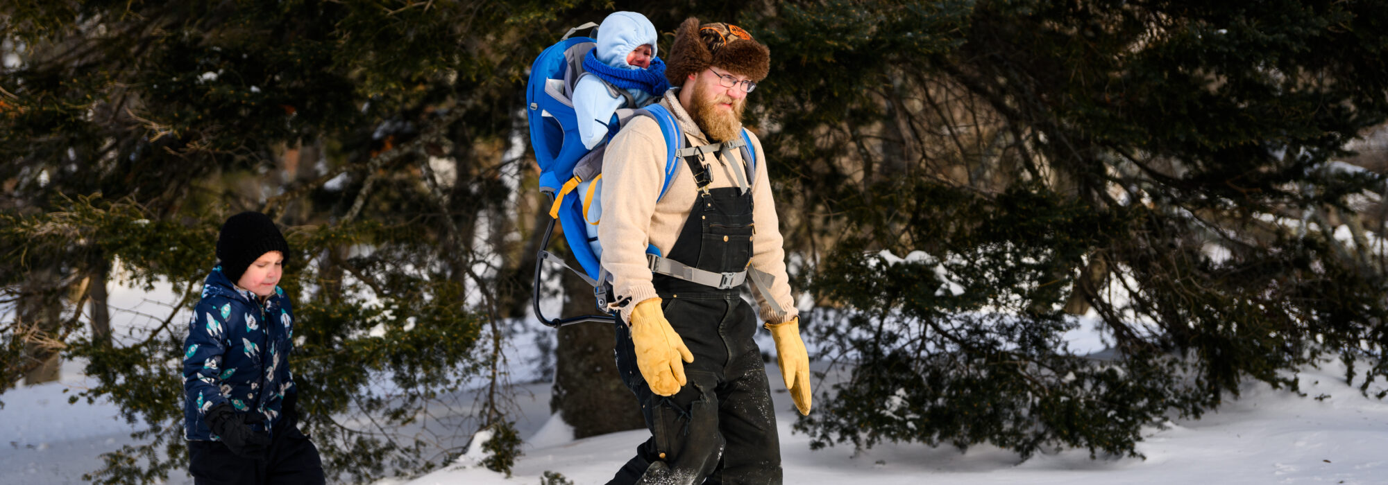 A man snowshoes with his two sons at Minnesota Discovery Center in northern Minnesota