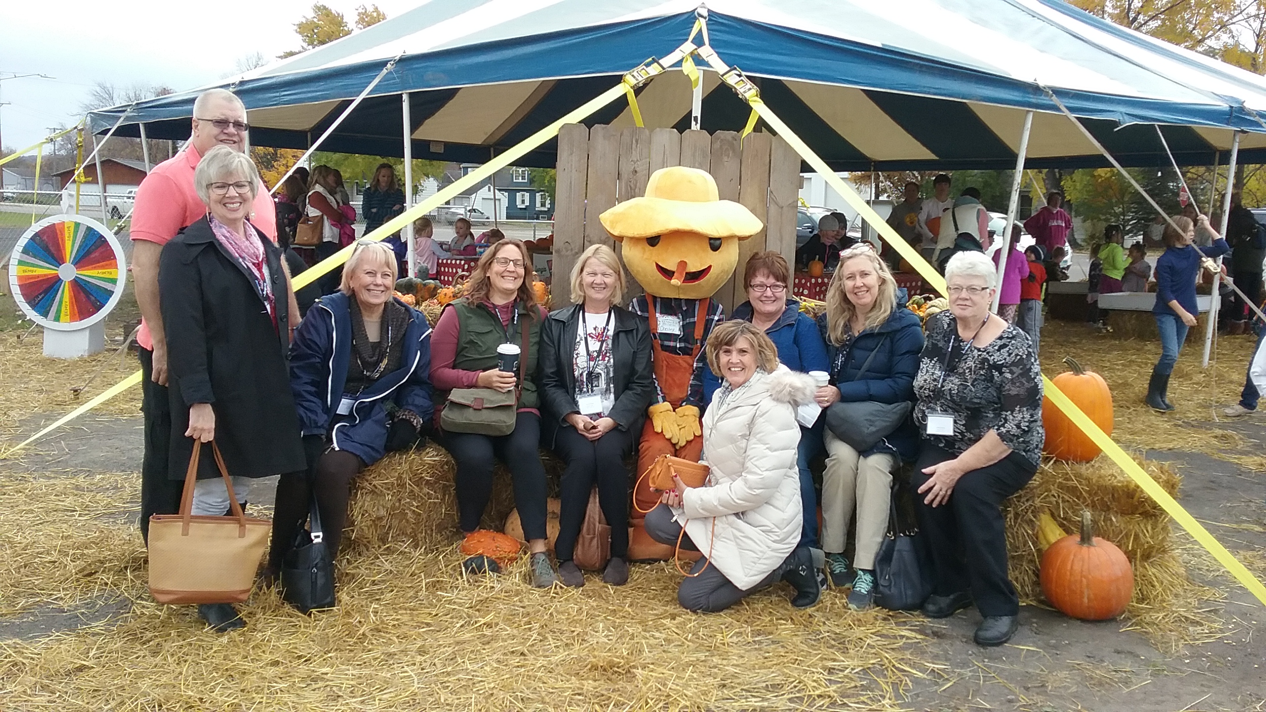 A group poses in front of Kunnari's Farm Market in the fall.