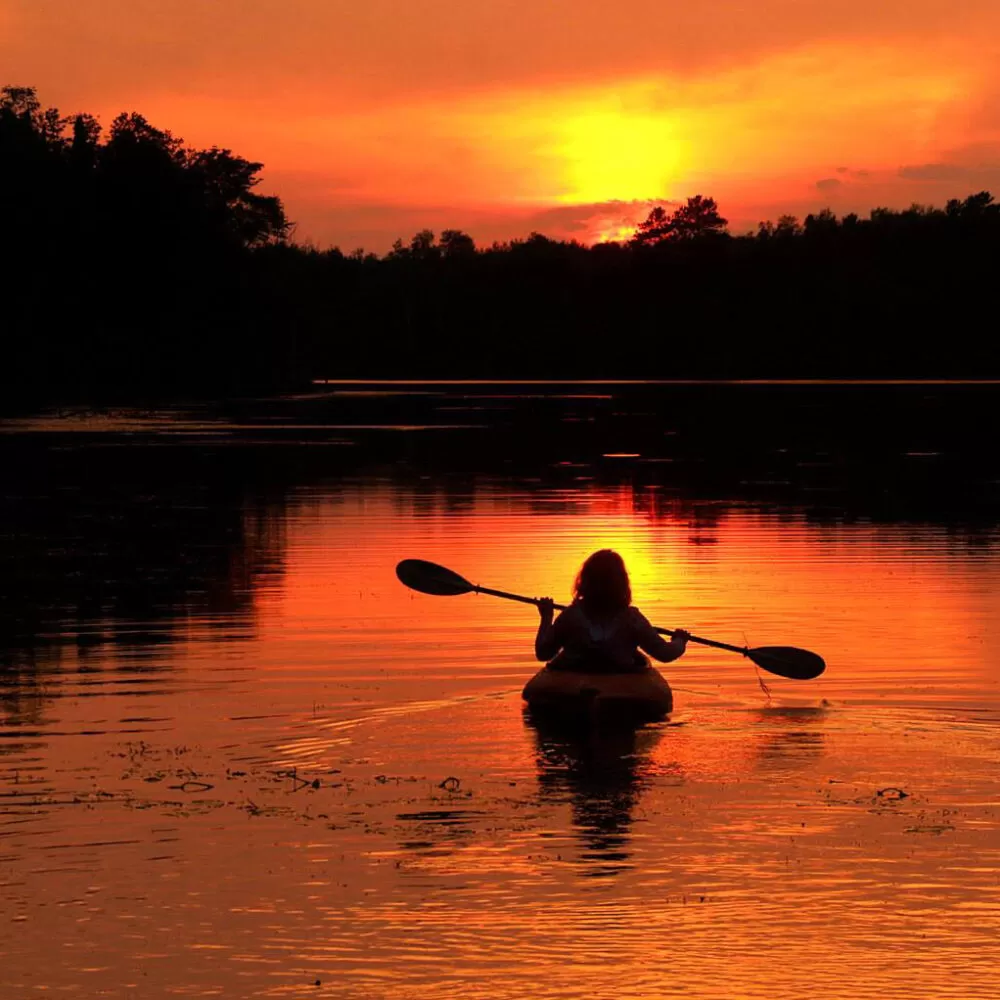 Kayaker on a sunlit lake in Minnesota