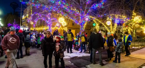 Familes gather around the Chisholm, MN City Hall and Library Thursday evening the celebrate the holidays.