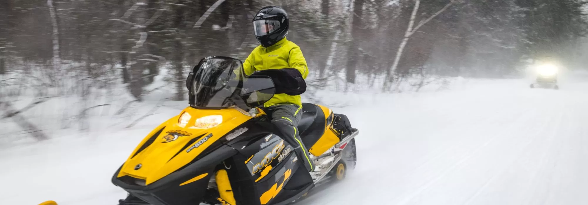 Yellow snowmobile rider 2023