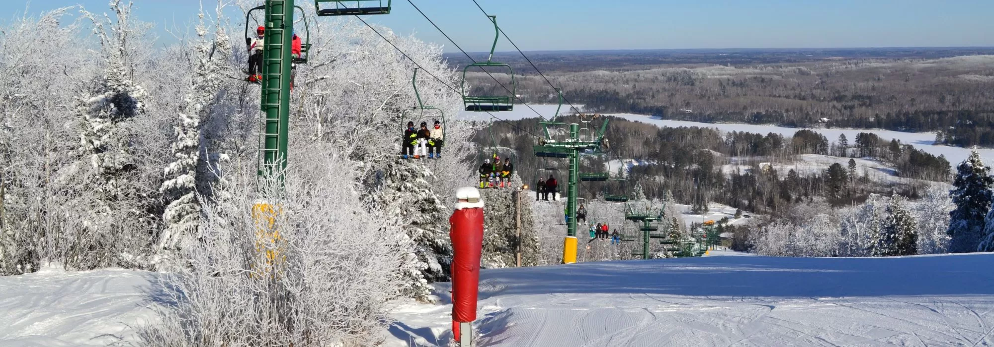 The ski slopes of Giants Ridge resort in northern Minnesota are shown in winter with full ski lifts.