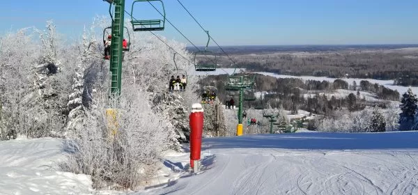 The ski slopes of Giants Ridge resort in northern Minnesota are shown in winter with full ski lifts.