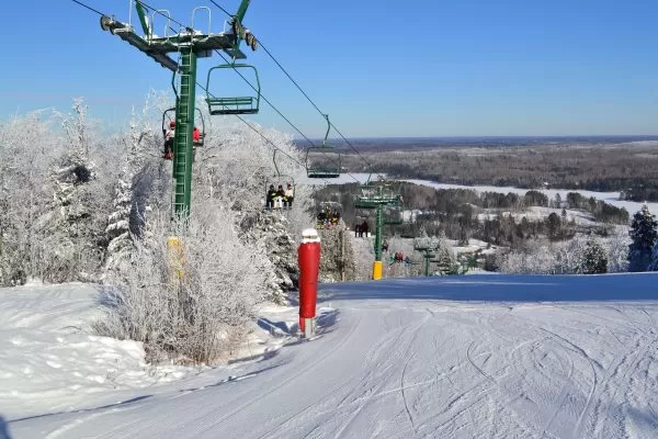 The ski slopes of Giants Ridge resort in northern Minnesota are shown in winter with full ski lifts.