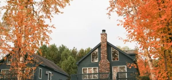 Fall leaves frame a view of a rental villa at Giants Ridge in northern Minnesota