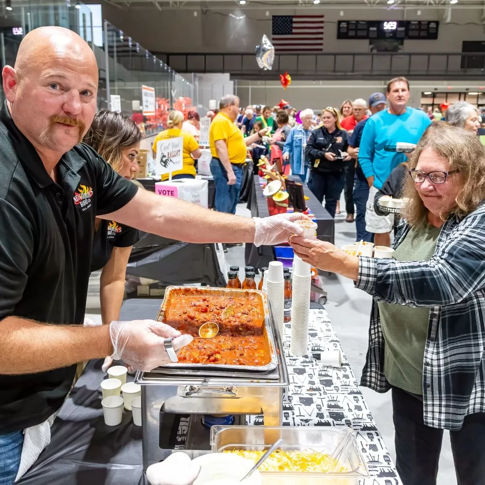 A chili chef hands out a tasting cup at the Rotary's annual chili cook off in Virginia MN