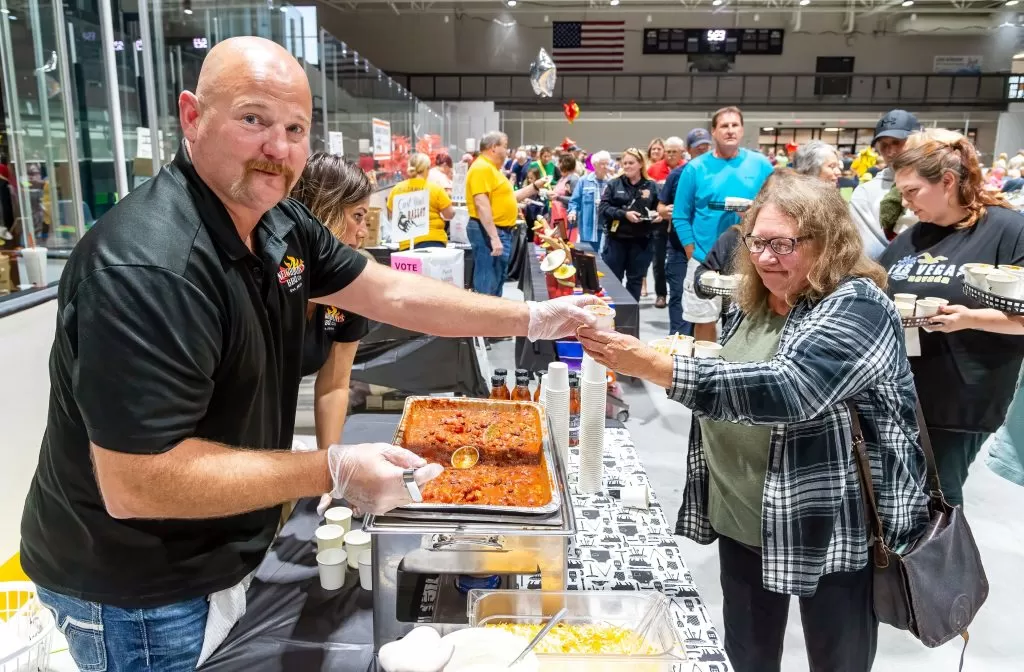 A chili chef hands out a tasting cup at the Rotary's annual chili cook off in Virginia MN 