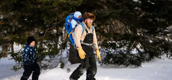 A man snowshoes with his two sons at Minnesota Discovery Center in northern Minnesota